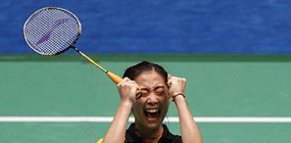 China's Wang Shixian celebrates her win over compatriot Wang Xin during the badminton women's singles final at the 16th Asian Games in Guangzhou